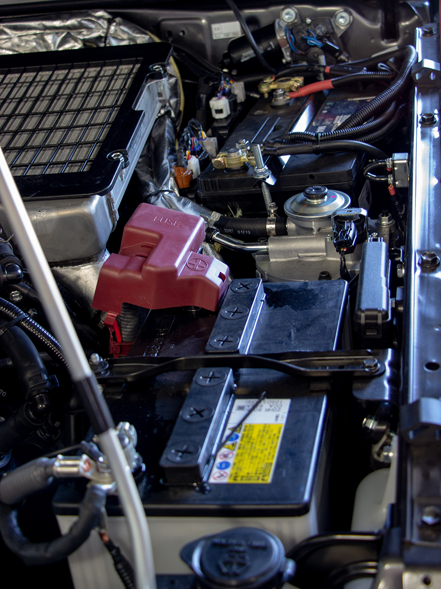 The engine bay of a 70 series Landcruiser equipped with a dual battery system.